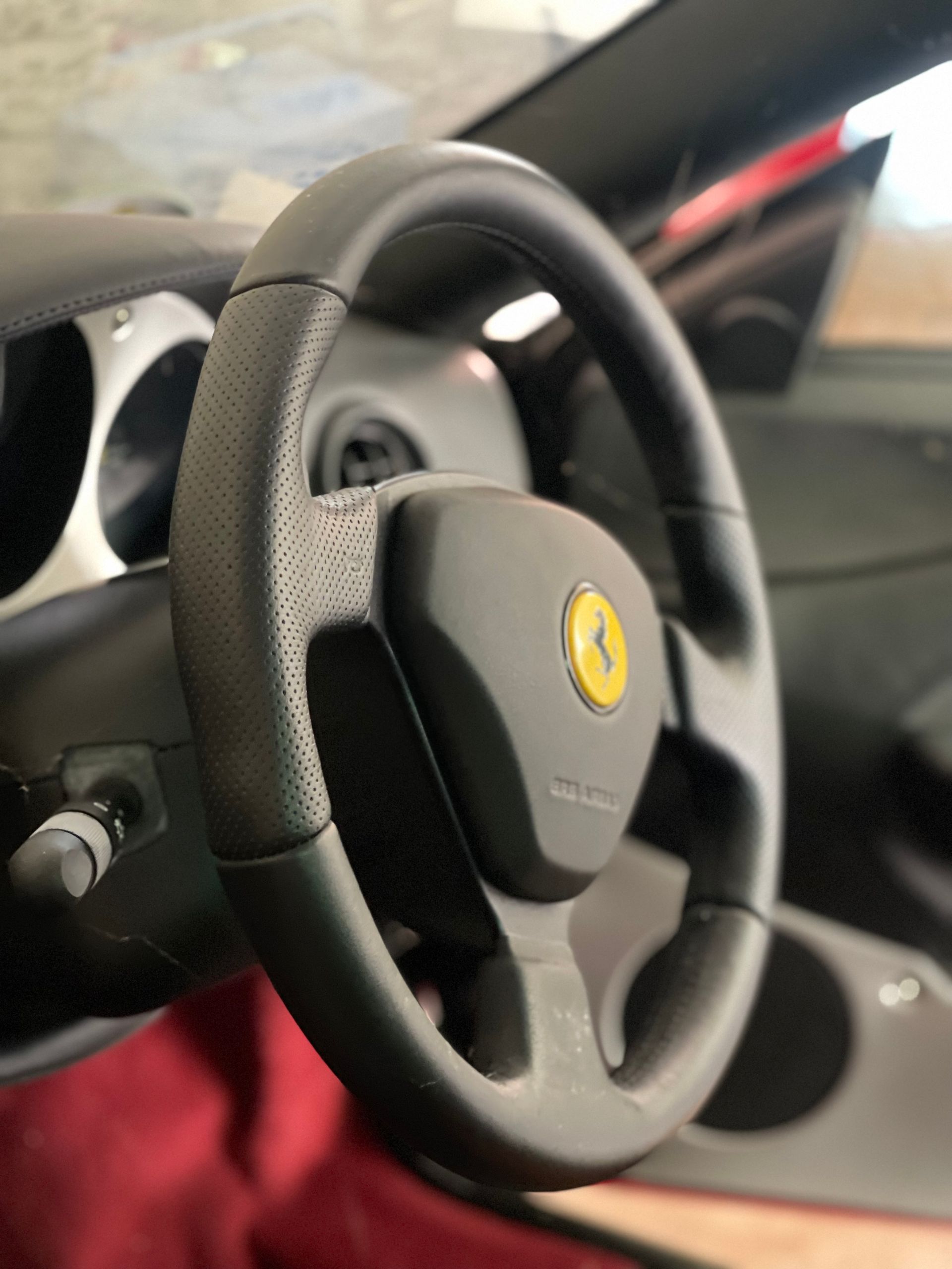 A close up of a steering wheel in a car