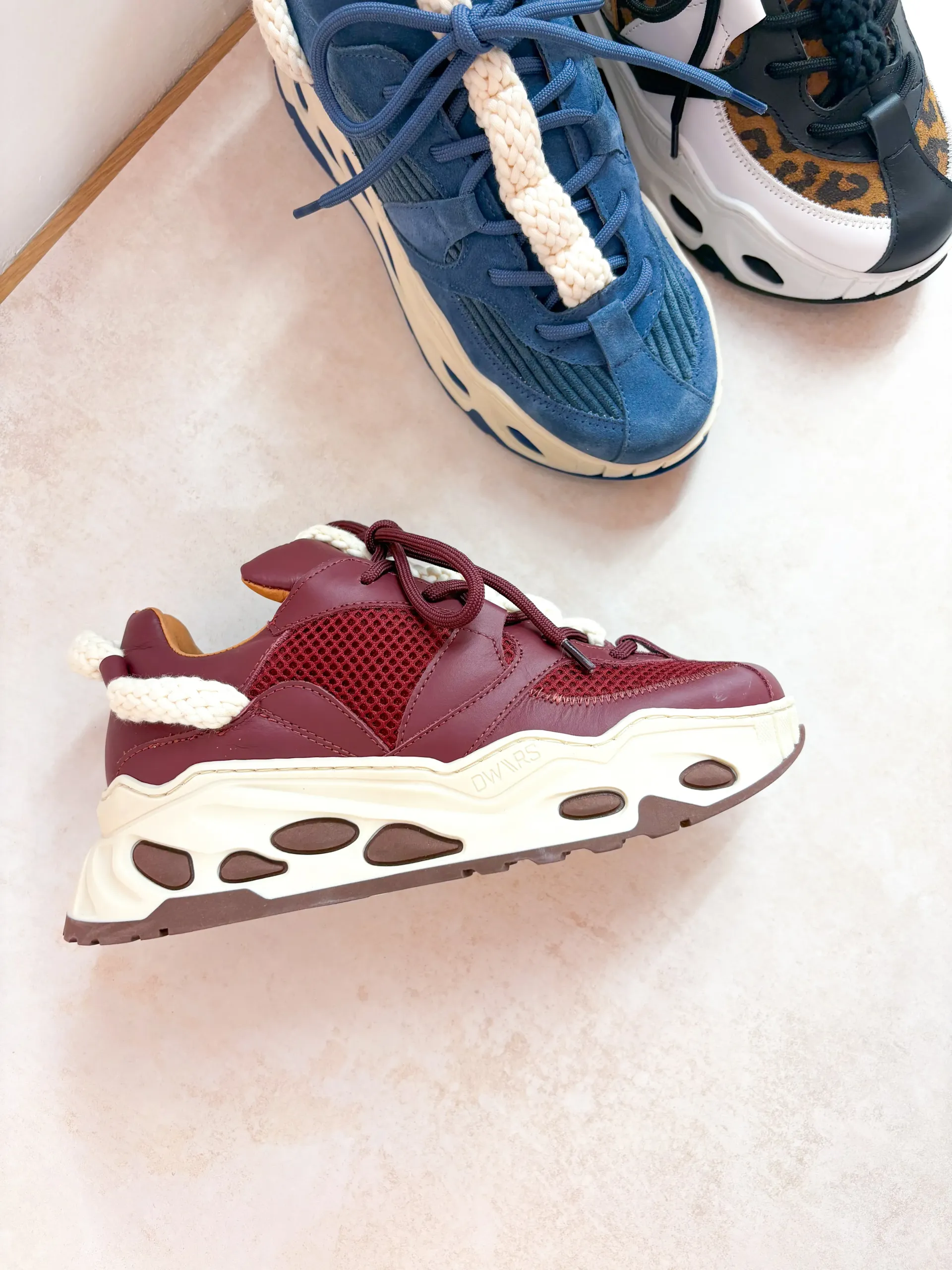 Bordeauxrode en crèmekleurige sneaker met dikke zool.