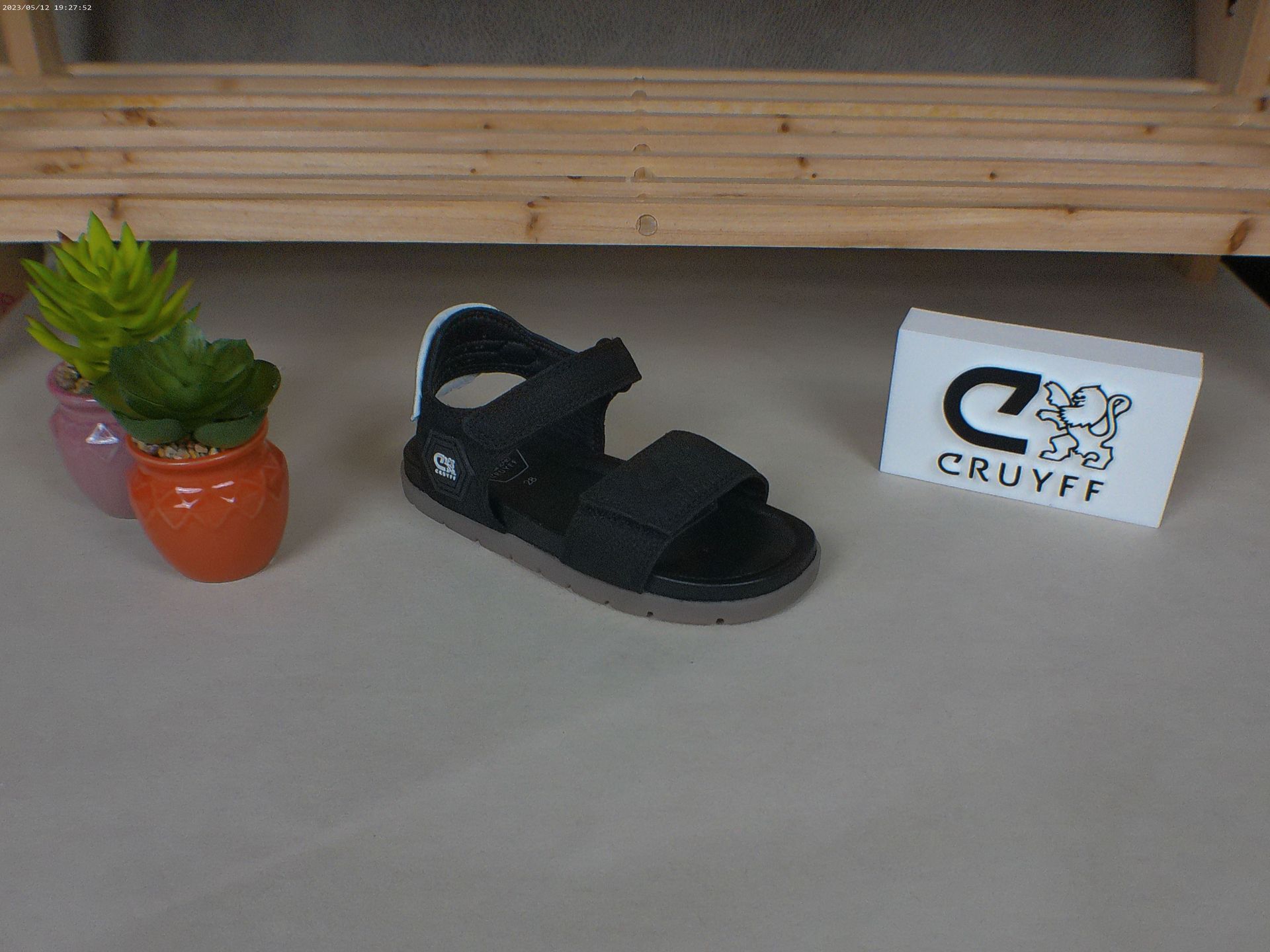 Een paar zwarte Cruyff-sandalen op een tafel