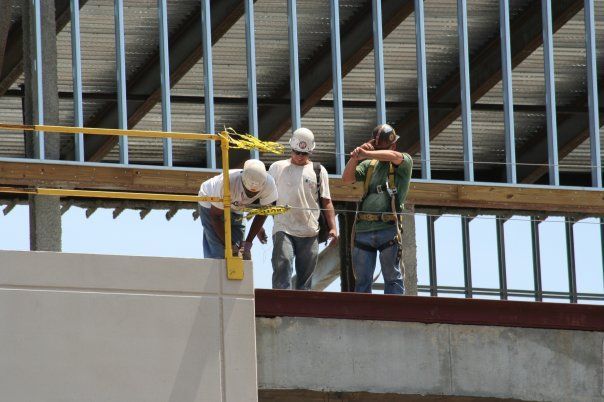 A group of construction workers are working on a building
