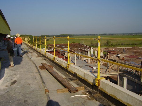 A group of construction workers standing on top of a building