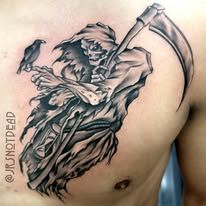 A black and white tattoo of a grim reaper with a scythe on a man 's chest.