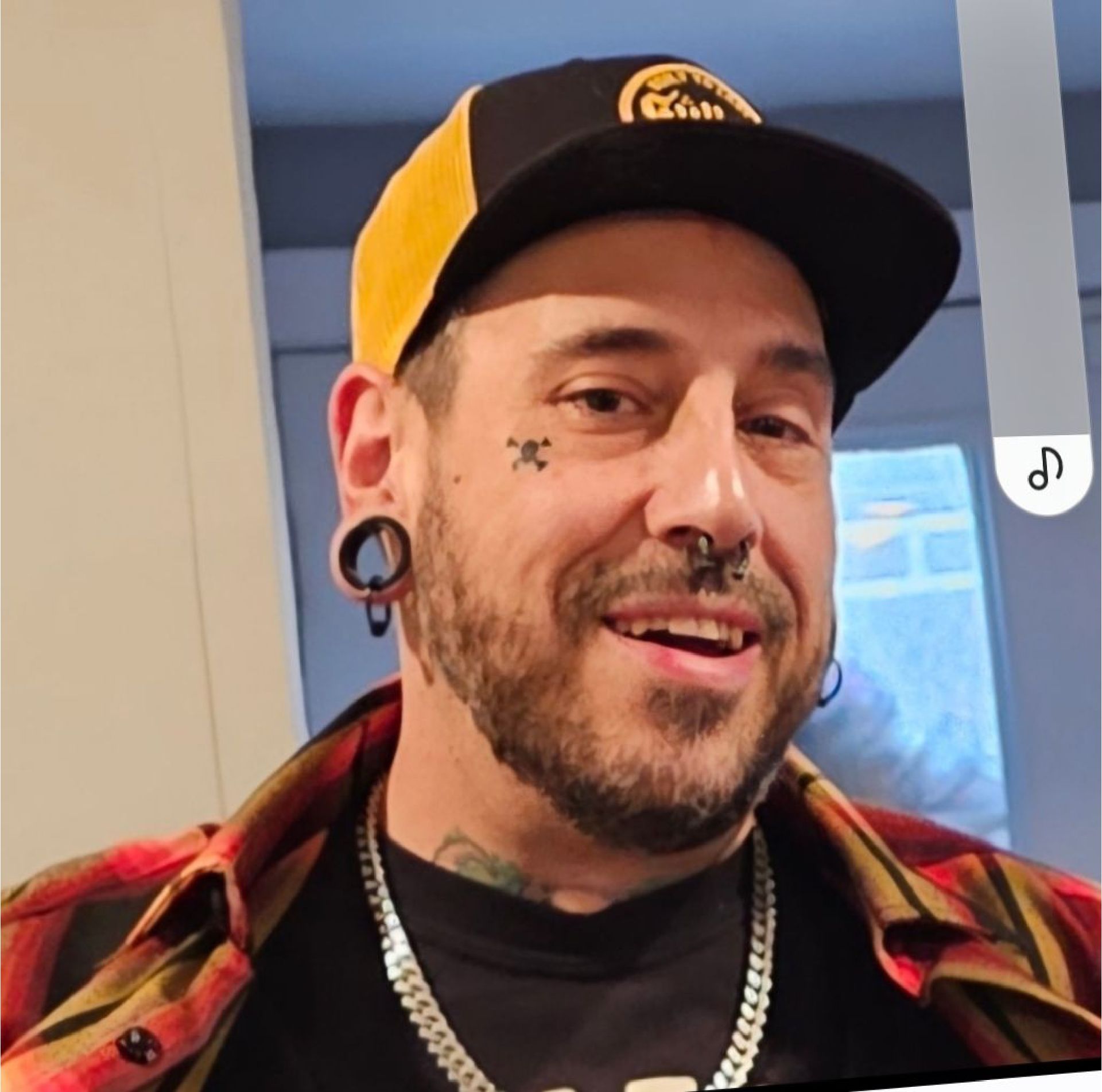 A man is getting a tattoo on another man 's leg.