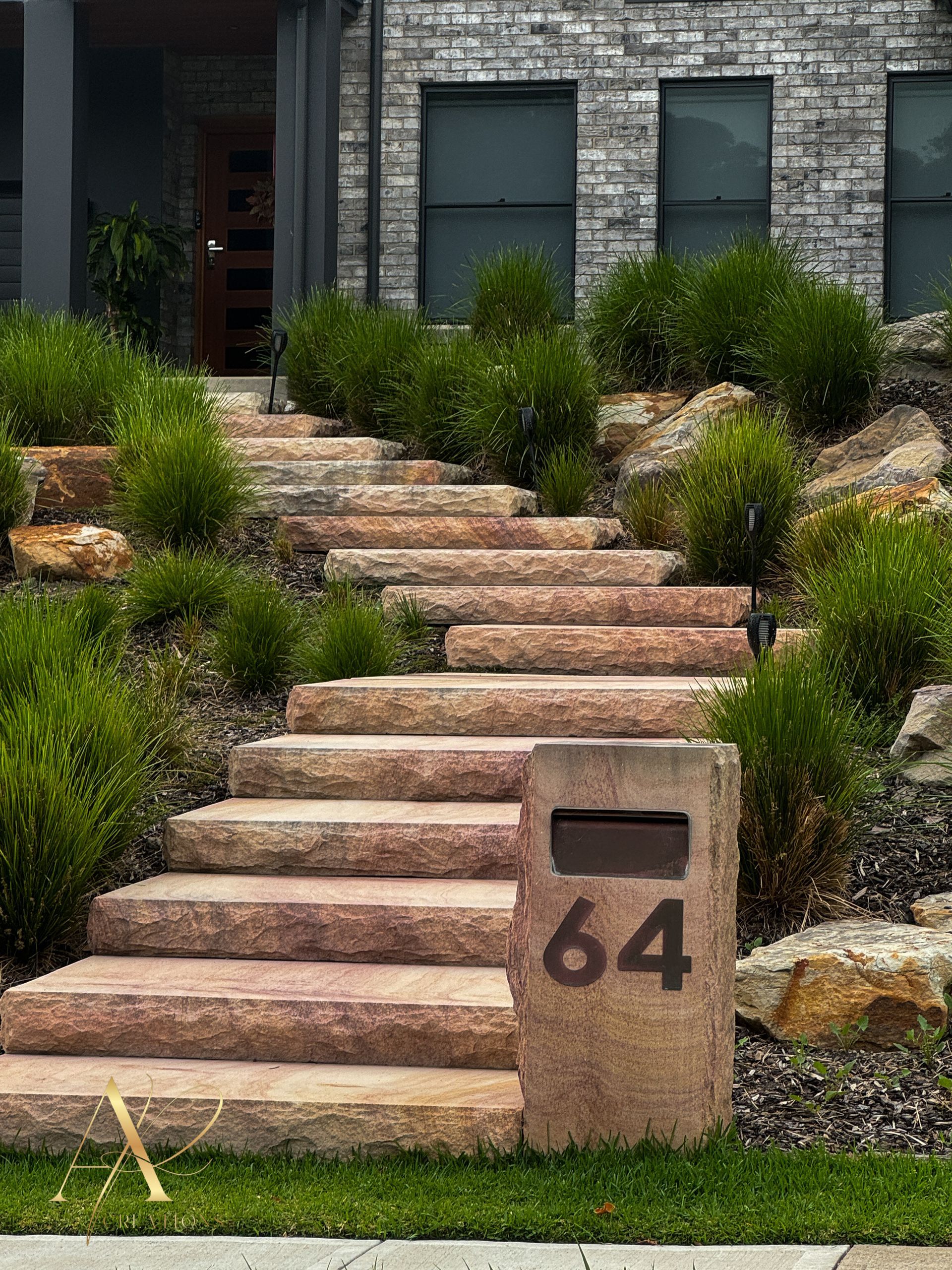 A set of stairs leading up to a house with a mailbox.