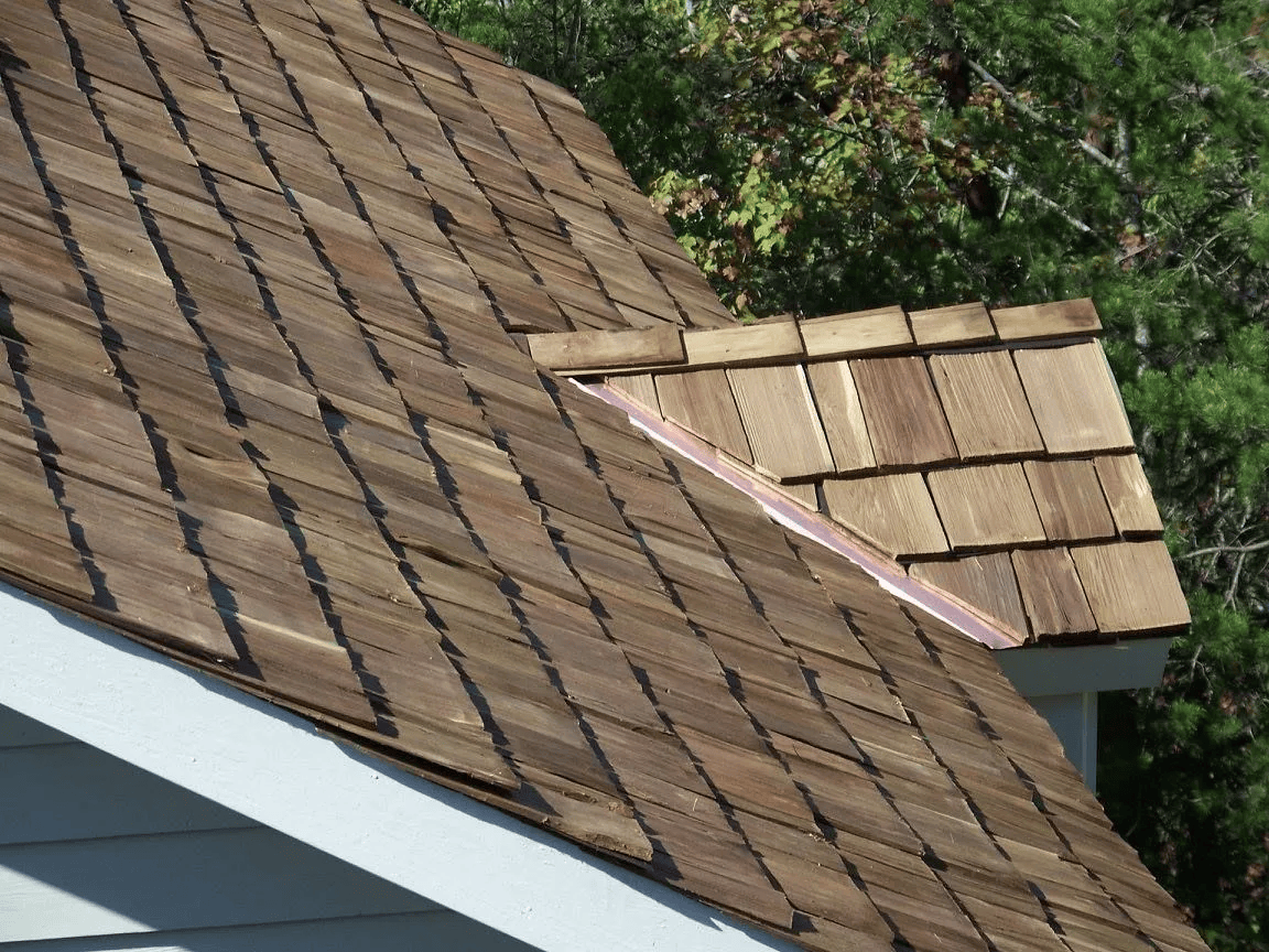 Brown cedar shake roof with copper flashing.