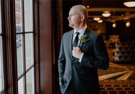 Groom looking out a window