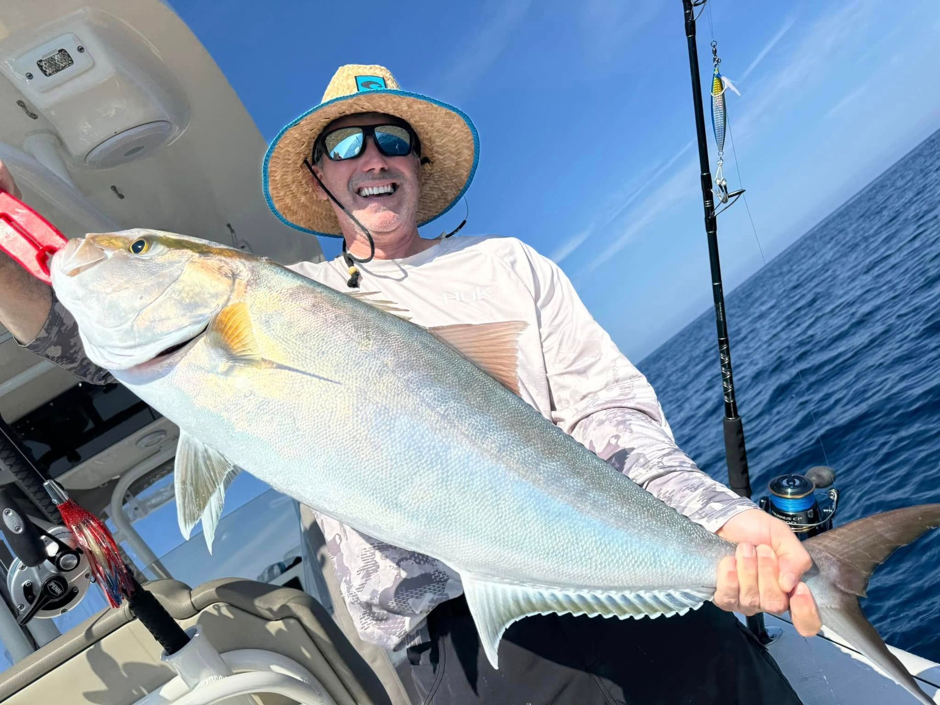Grandfather and grandson driving pontoon boat.