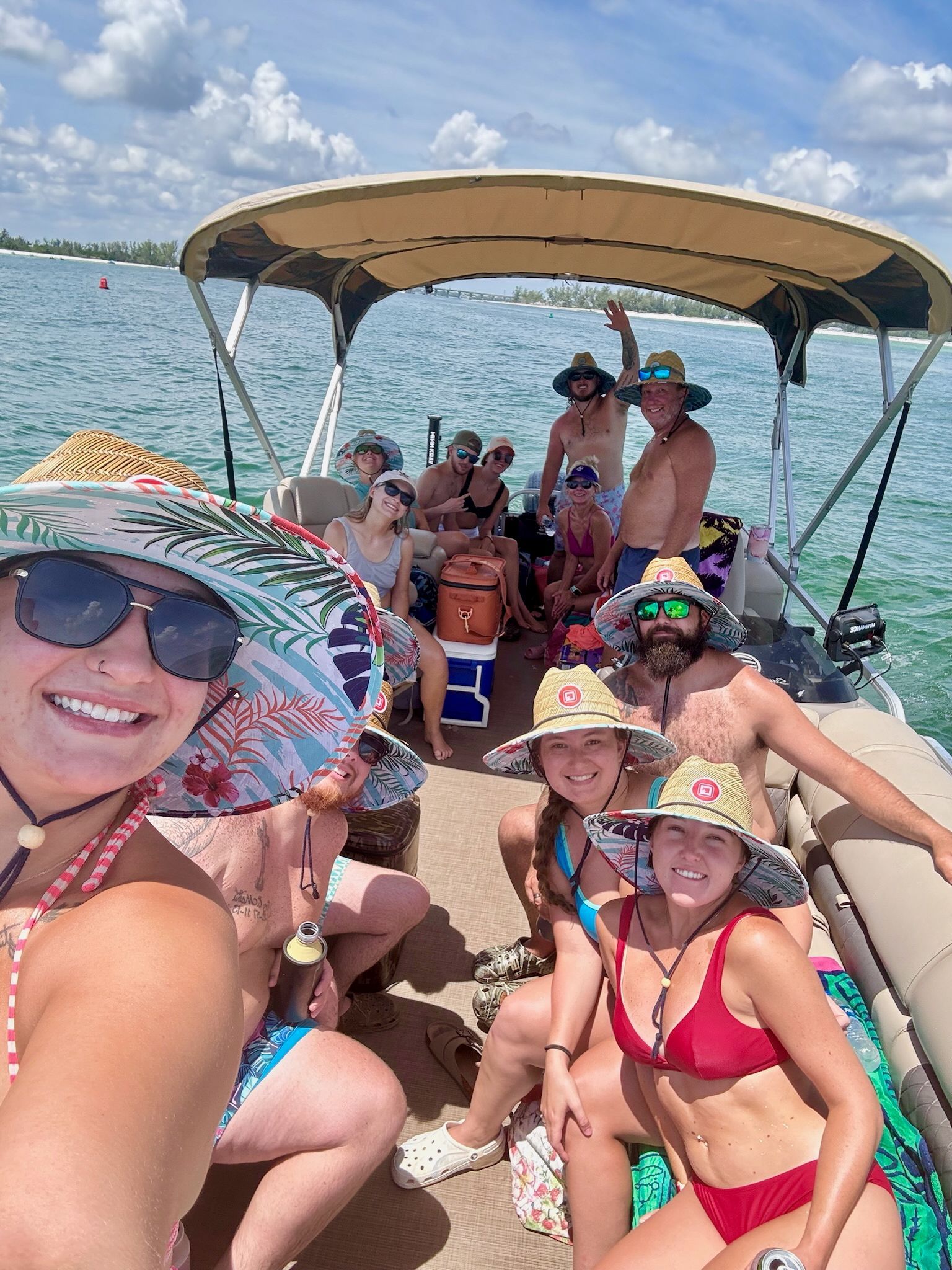 Grandfather and grandson driving pontoon boat. 