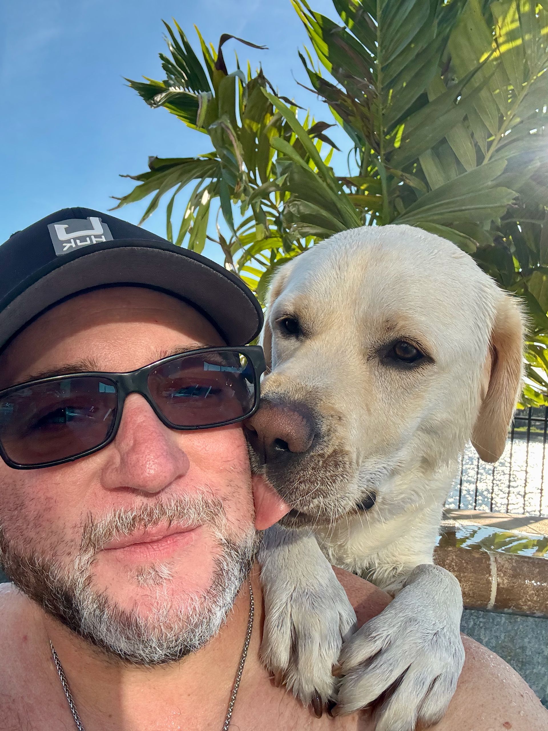 Grandfather and grandson driving pontoon boat. 