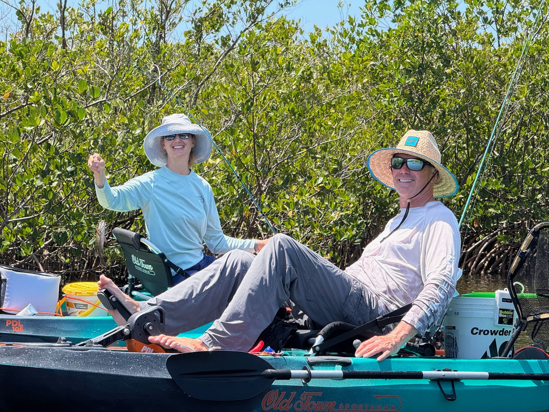 Grandfather and grandson driving pontoon boat. 