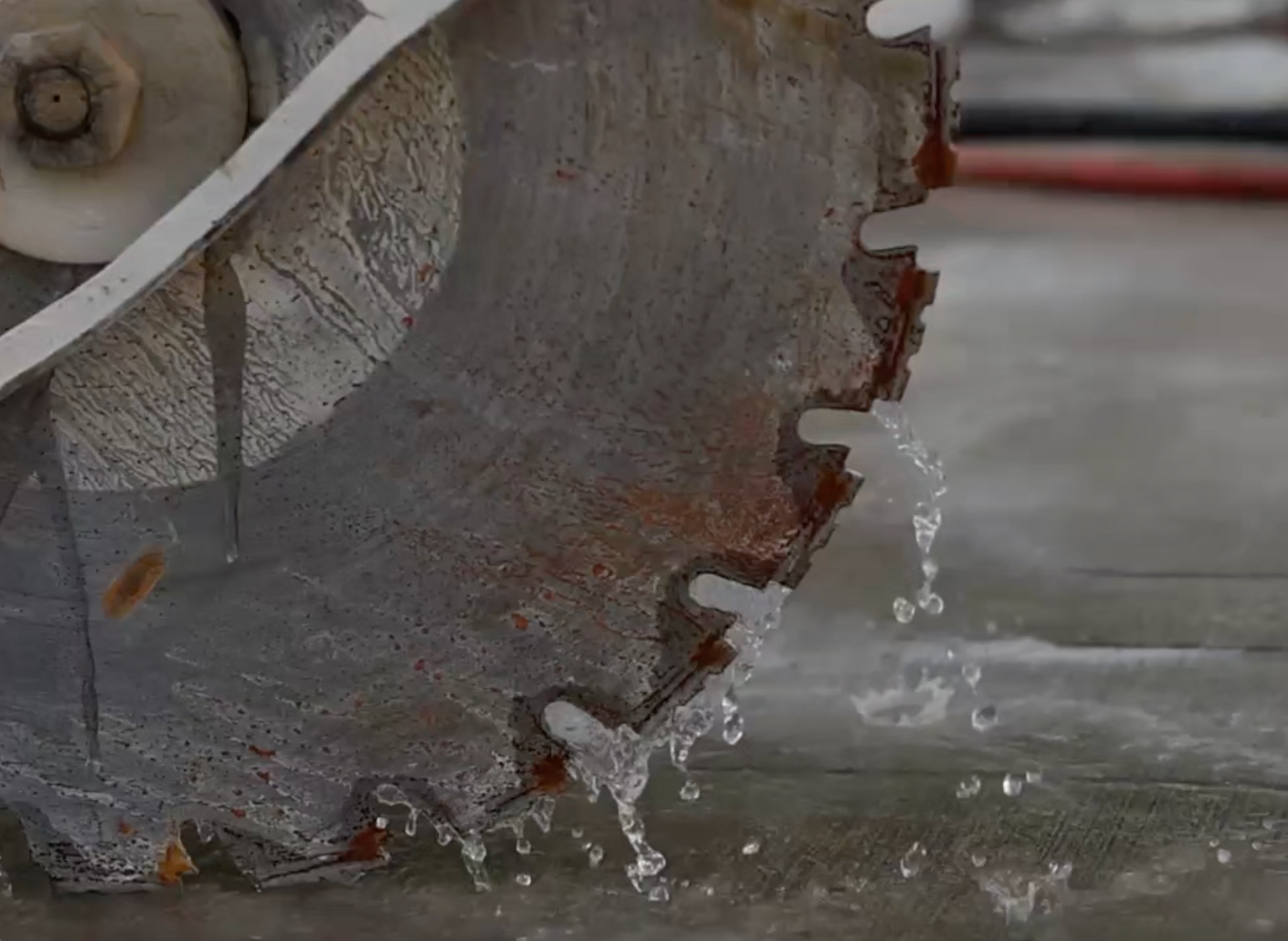 A person is using a circular saw to cut concrete.