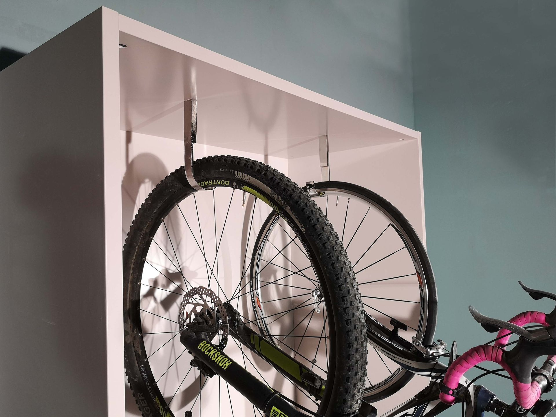 particolare di mobile contenitore con ganci da supporto per biciclette