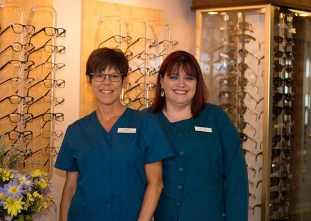 Eyeglasses Collection Behind Two Women – Aberdeen, WA – Twin Harbors Eye Center