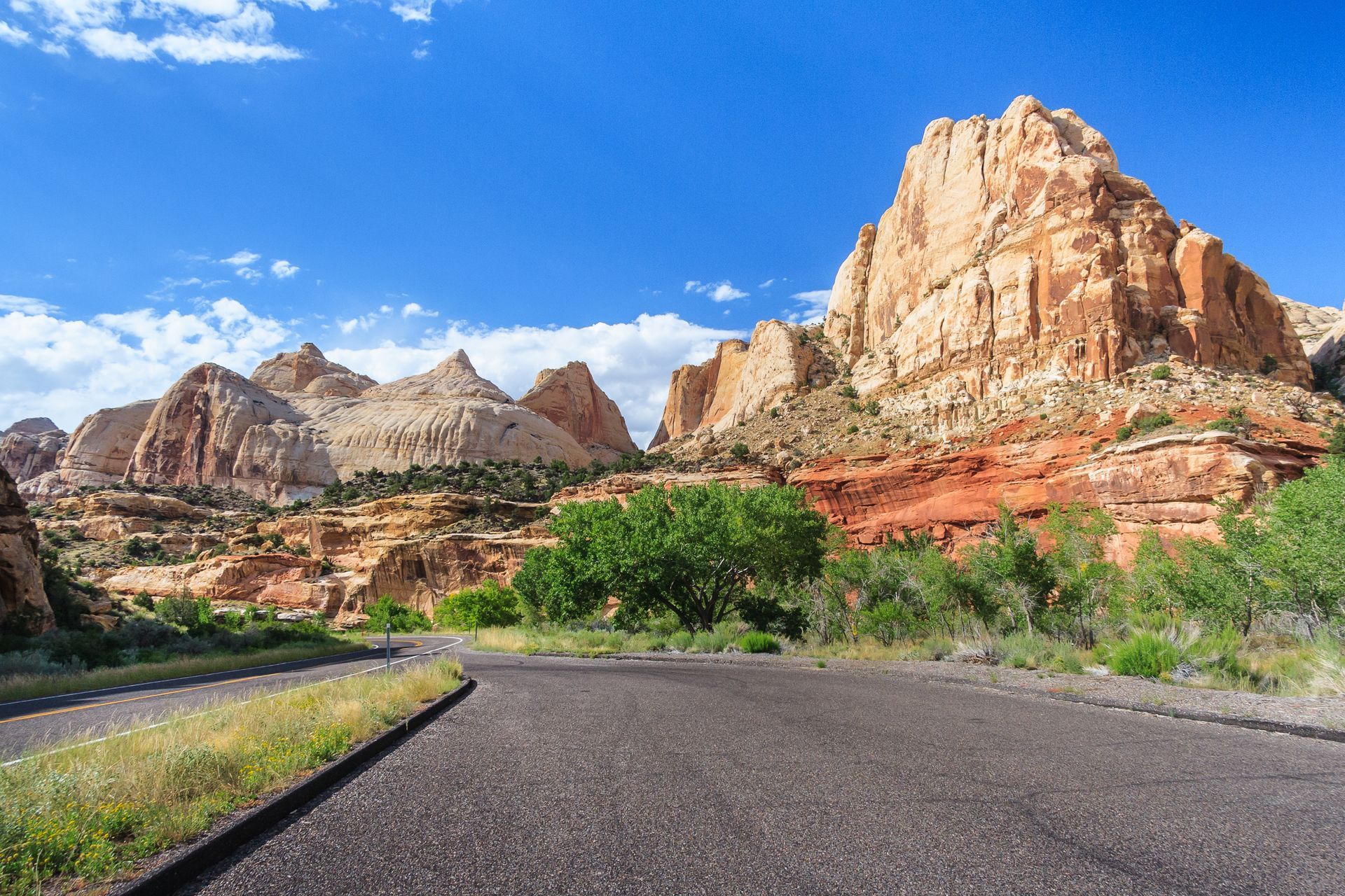A road in the desert with mountains in the background.