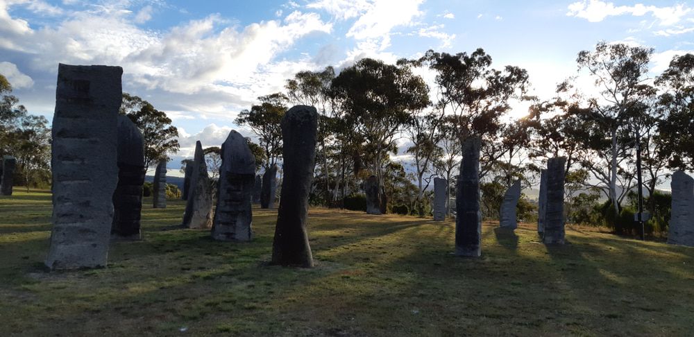 Stone Columns in A Field on A Grassy Hill with Trees — New England Towing in Glen Innes, NSW