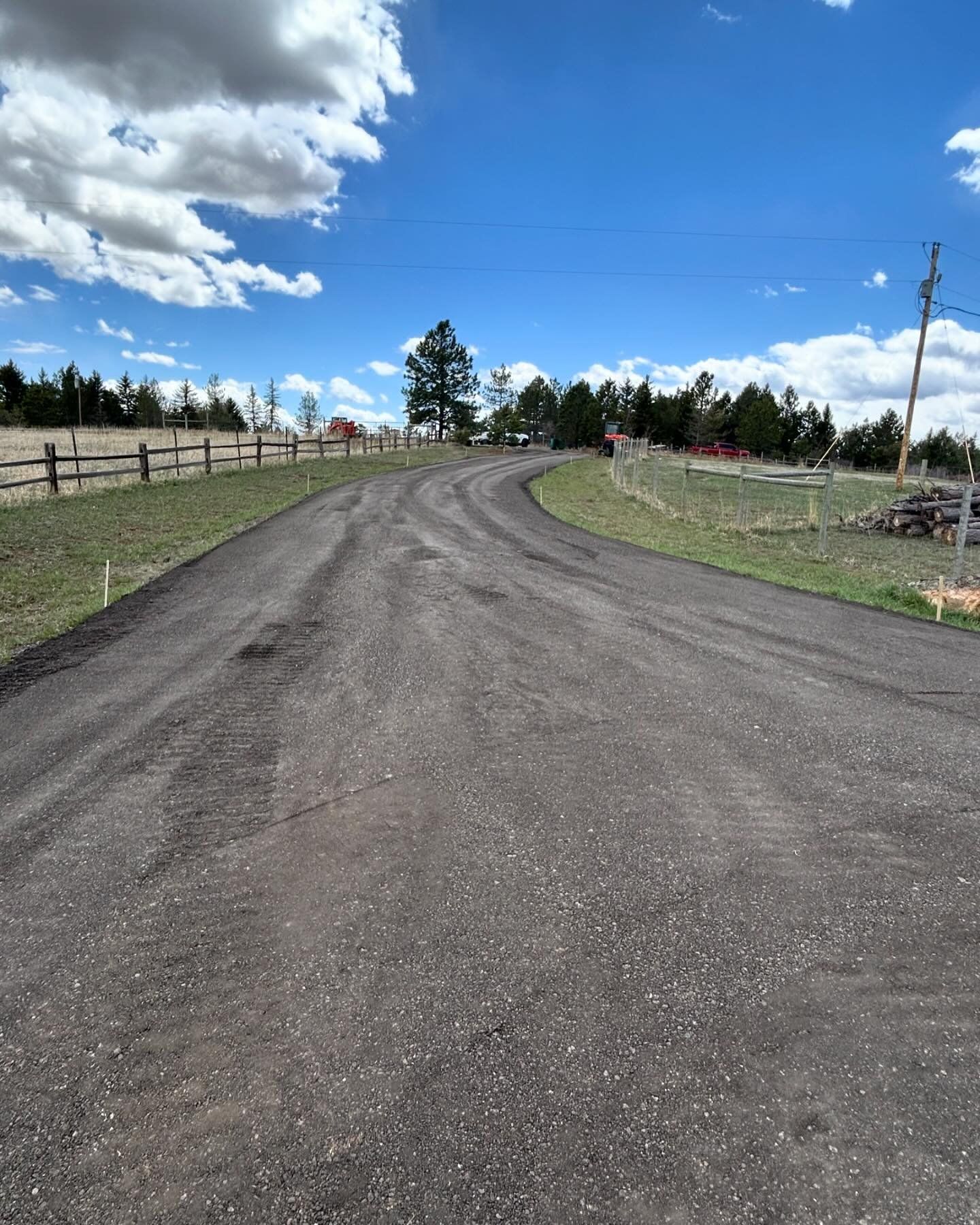 A road with a wooden fence on the side of it
