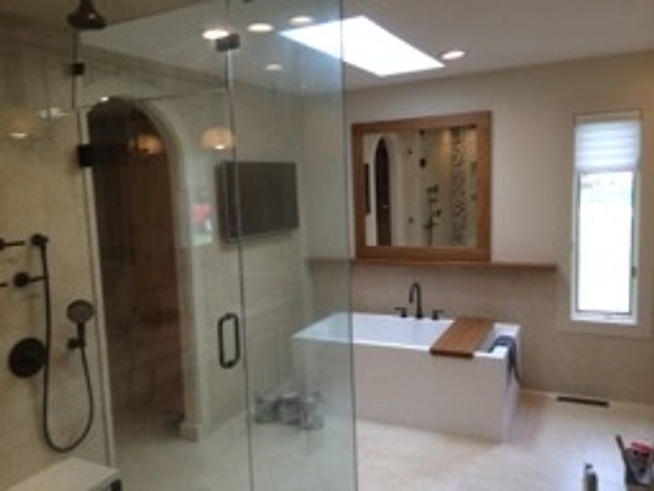 A bathroom with a bathtub and a walk in shower