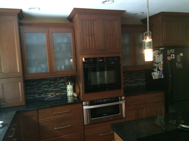 A kitchen with stainless steel appliances and wooden cabinets