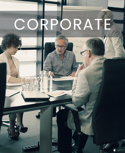 A group of people sitting around a table with the word corporate above them