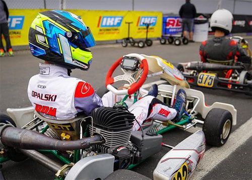 Max Opalski is sitting in a go kart on a track.