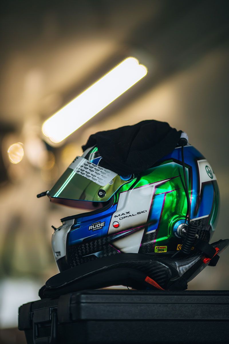 Max Opalski's racing helmet is sitting on top of a black case.