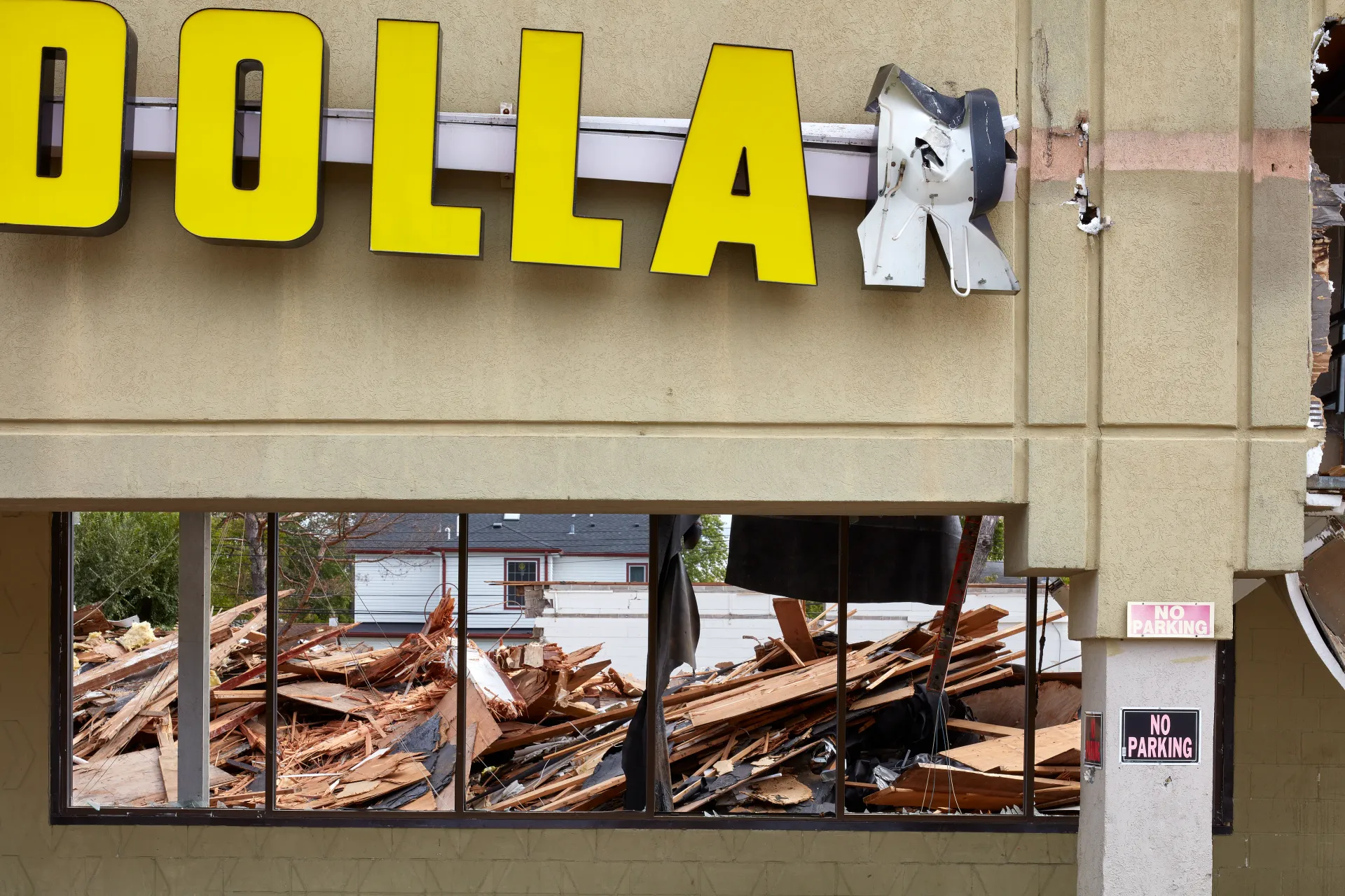 Dollar Store. A strip mall where tenants have been strategically forced out by new owners who have since converted it into a Mosque parking lot. Streamwood, Illinois 2021 - Robert Swiderski