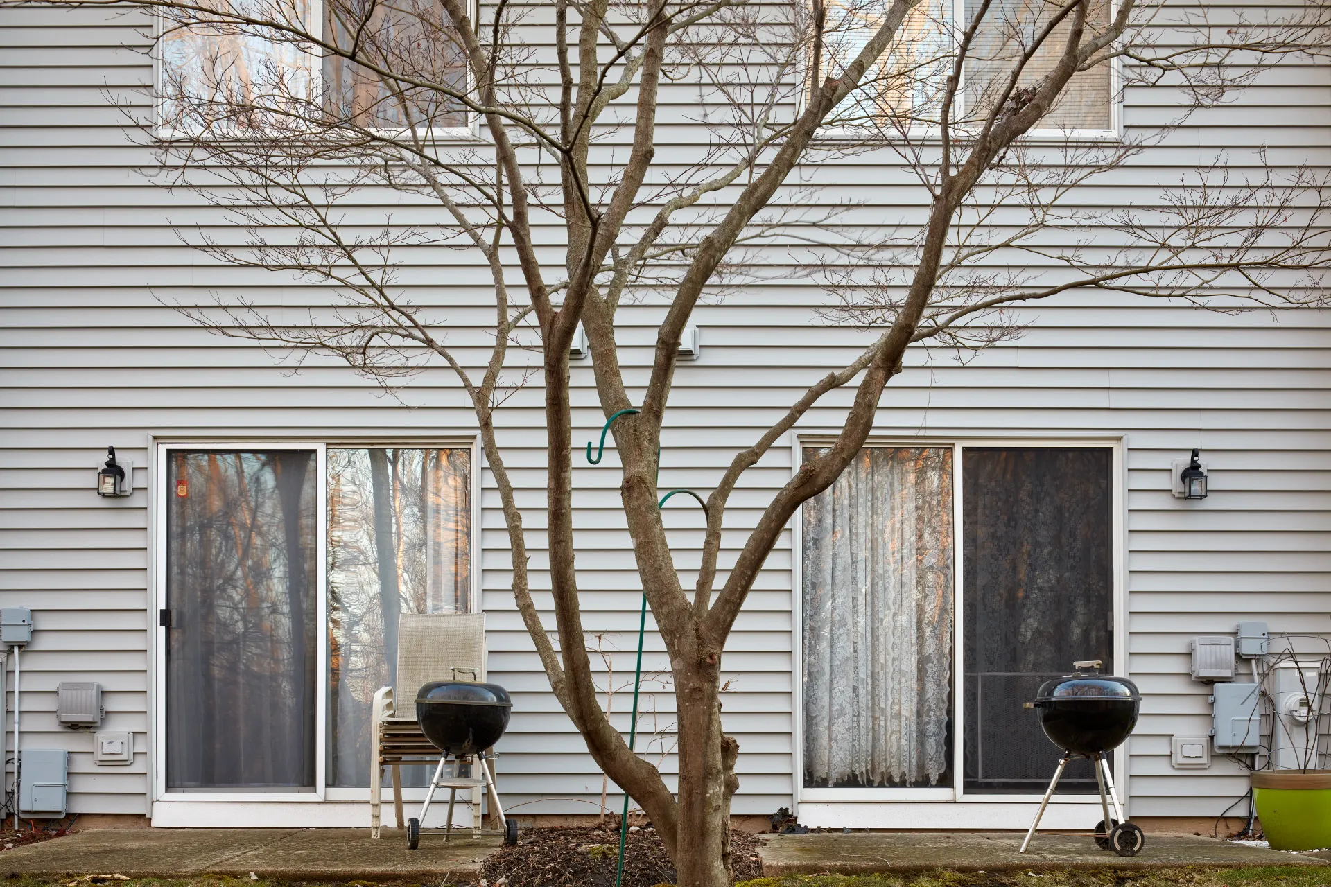 The American Barbecue. The patio and a Weber grill - the ubiquitous symbols of American weekend; a monument of where we are and who we are. Streamwood, Illinois 2023 - Robert Swiderski
