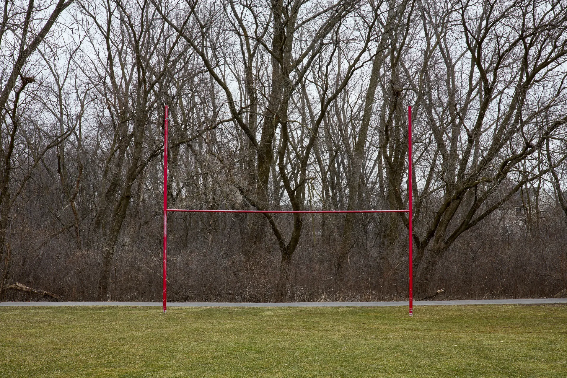 Goal posts. Football field in a neighborhood recreational area with a view of my home obstructed by trees. Streamwood, Illinois 2023 - Robert Swiderski