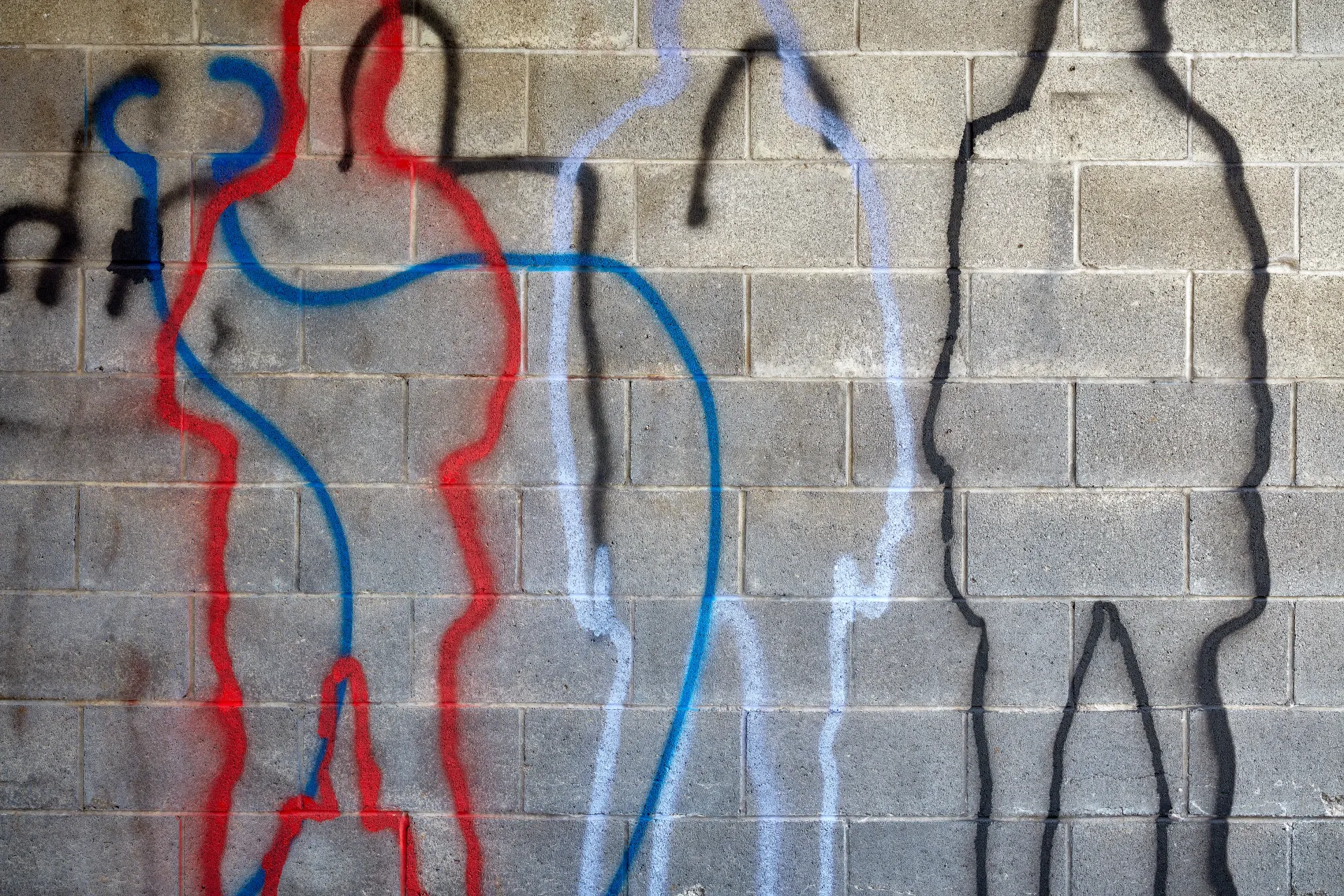Body outlines. Graffiti representing the town’s demographic change. The red, white and blue are being overshadowed by the undefined stranger. Streamwood, Illinois 2023 - Robert Swiderski
