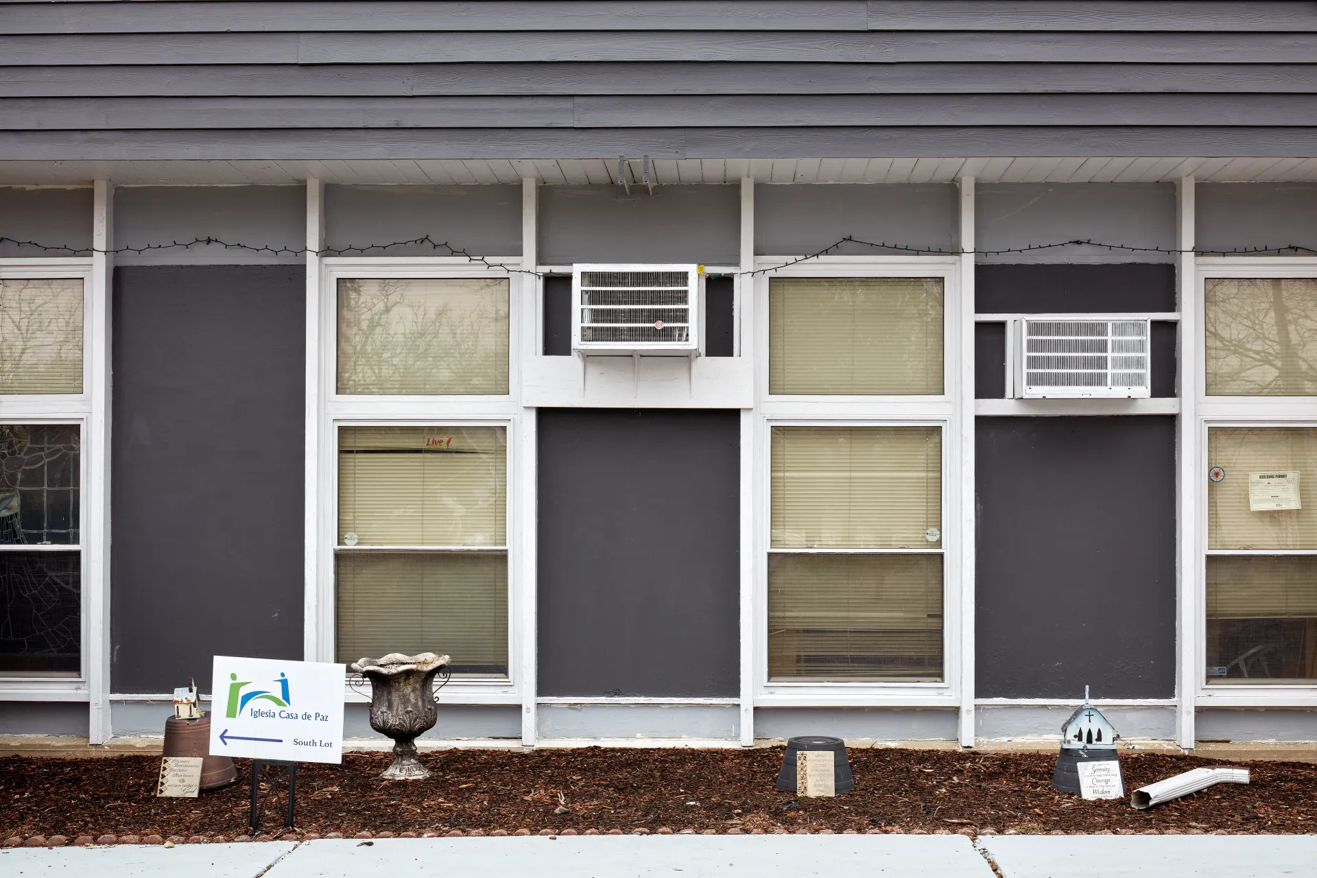 Leave the rest to God. The facade of a humble church, made modern by employing the current must have feature of every updated American home - grey and white. Streamwood, Illinois 2023 - Robert Swiderski
