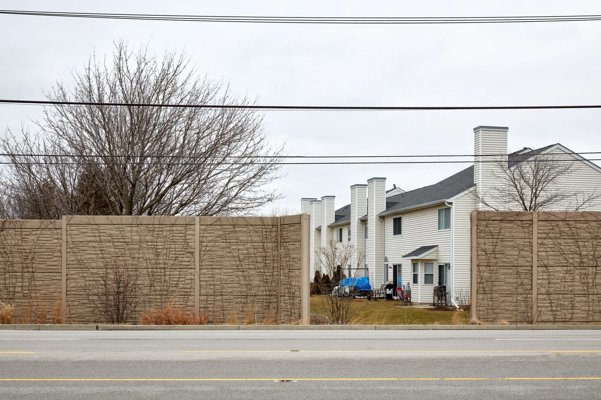 Behind the sound proofing wall - a metaphor of the imprisonment of American suburbia. Streamwood, Illinois 2023 - Robert Swiderski