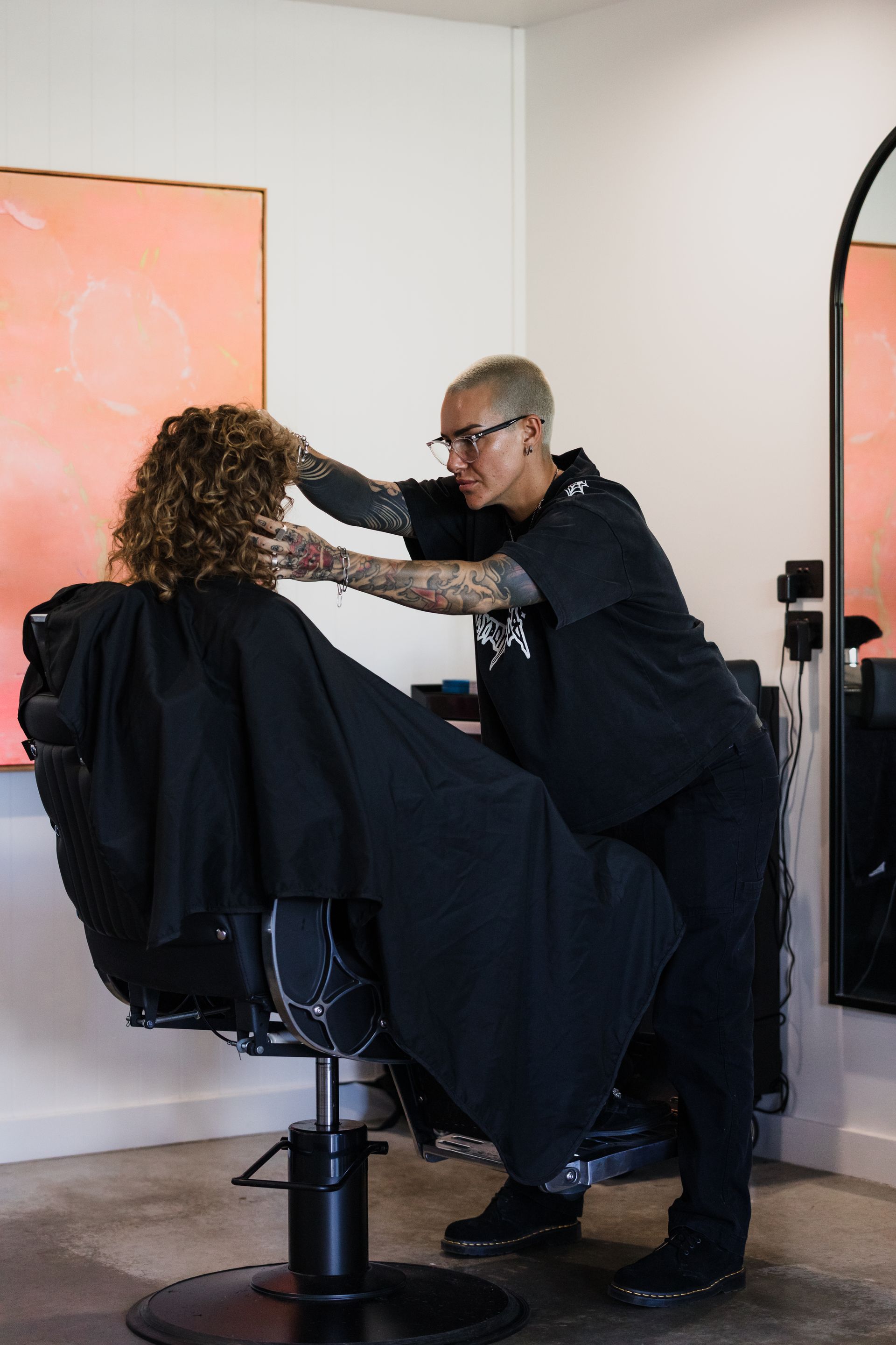 a Man is Getting His Hair Cut by a Barber in a Barber Shop — Habitat Barbershop Byron Bay In Byron Bay, NSW