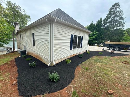 A Brick House With A Screened In Porch And A Garden In Front Of It - Roanoke, VA - Duncan Design & Landscaping LLC