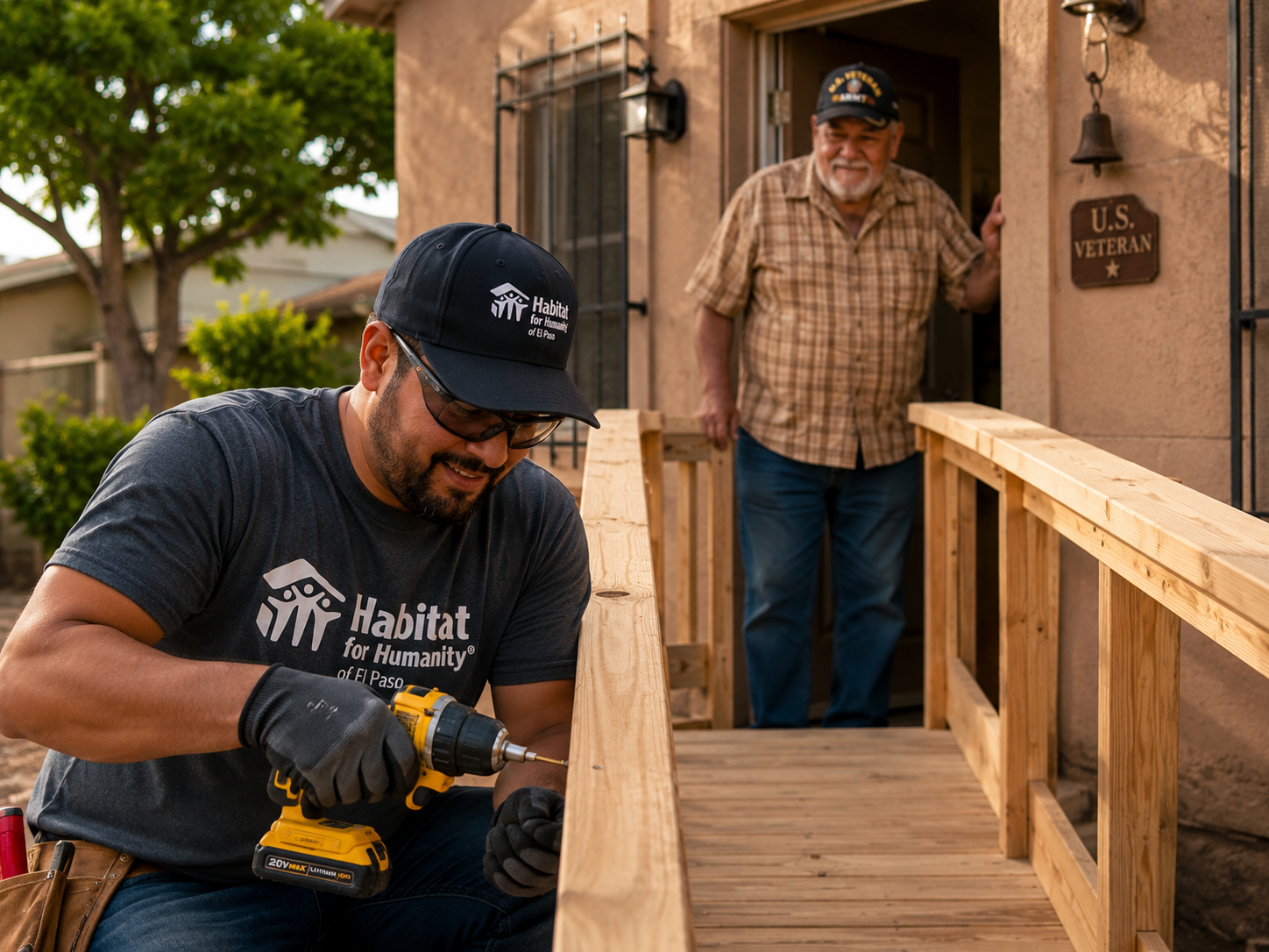 Habitat volunteer builds a wheelchair ramp as an older veteran watches from the front porch.