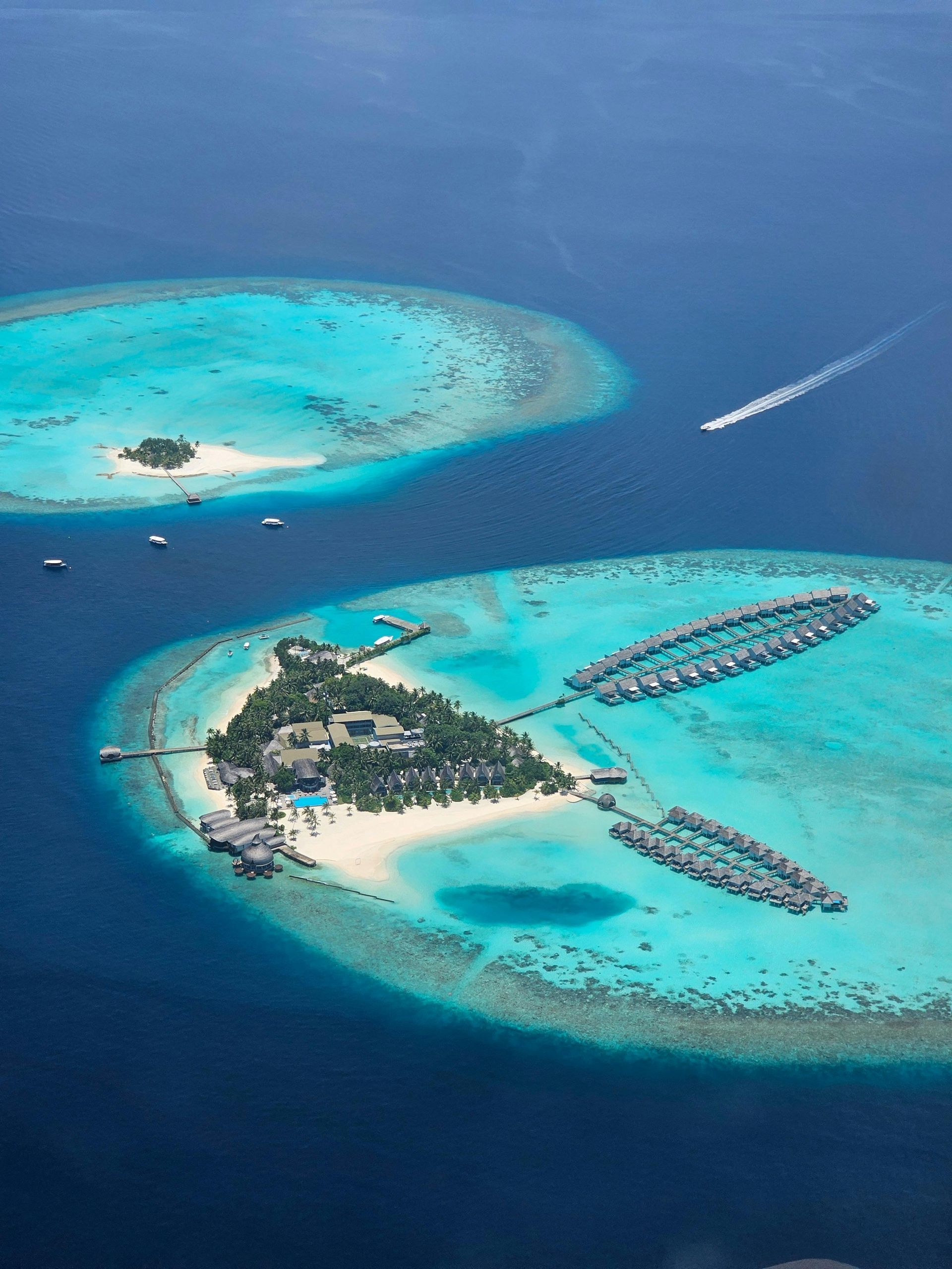 An aerial view of two islands in the middle of the ocean in the Maldives