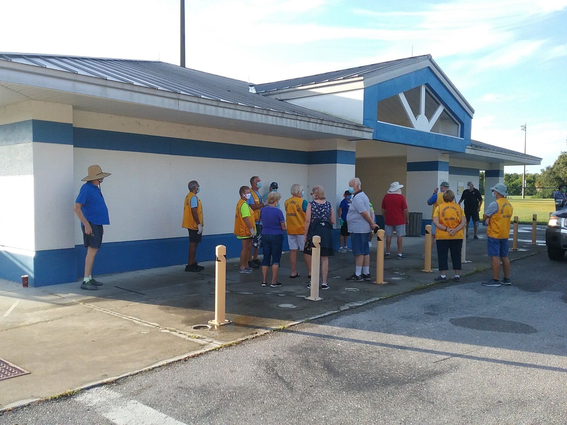 A group of people are standing outside of a building