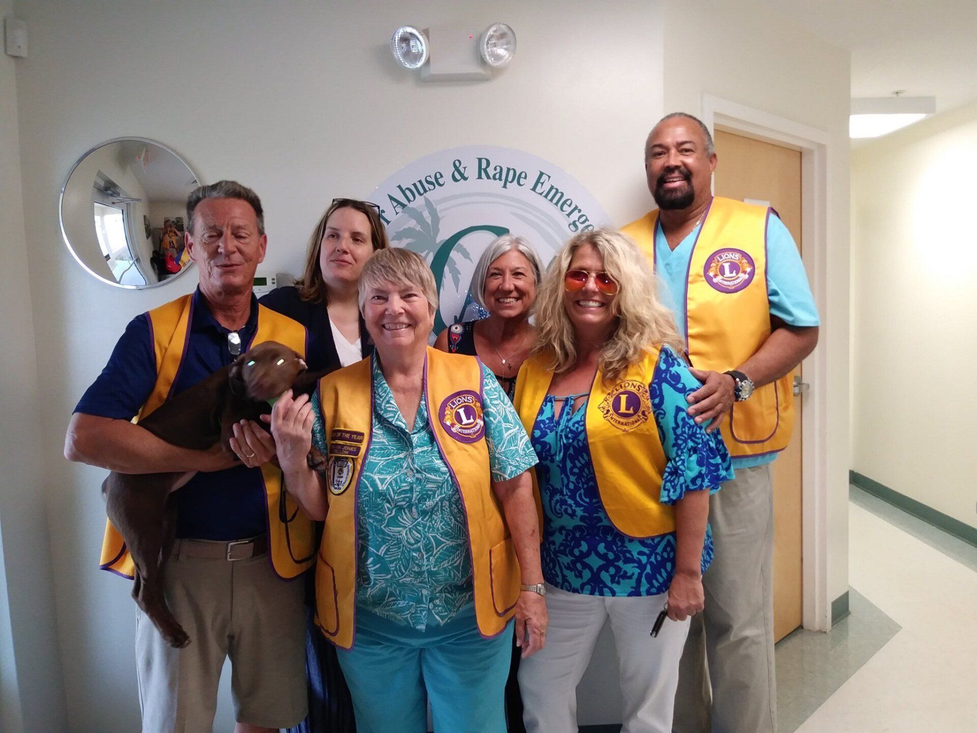 A group of people wearing lions vests are posing for a picture