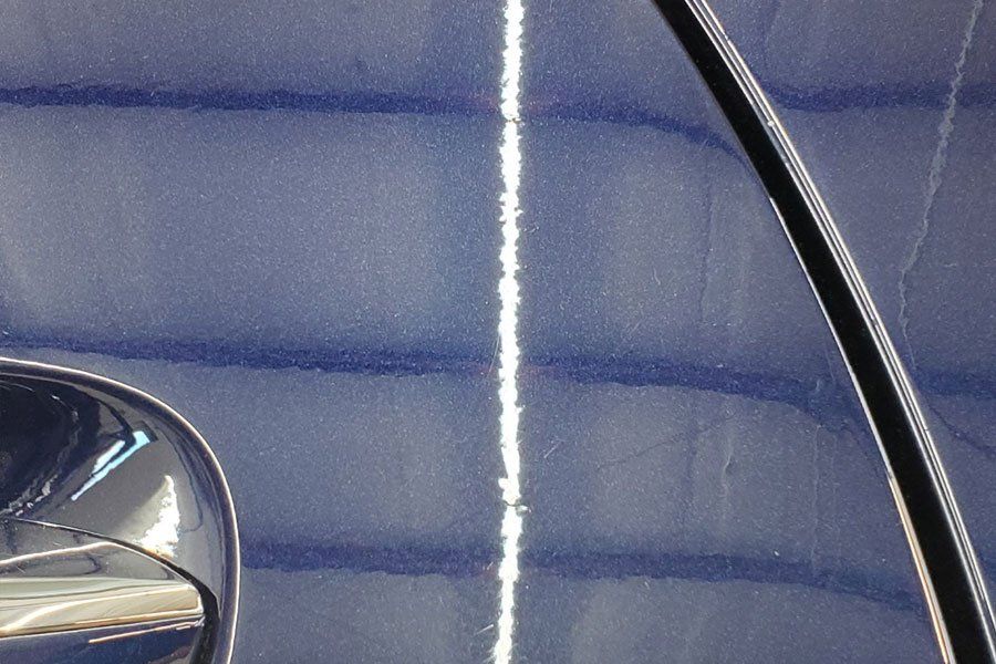 a close up of a blue car with a white line on it