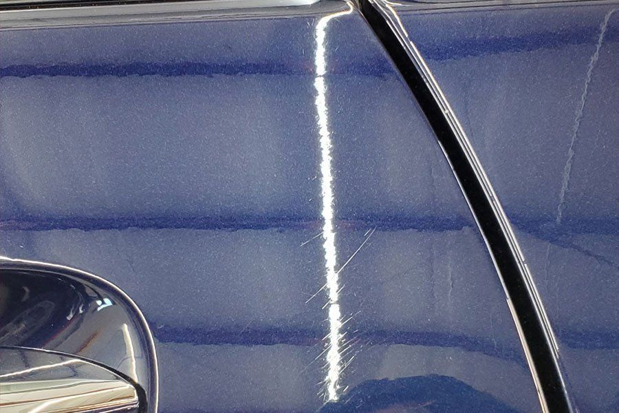 a close up of a blue car 's door