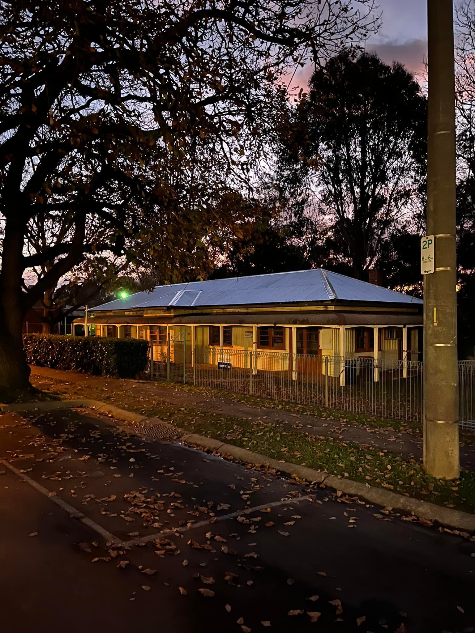 A house with a white roof is lit up at night.