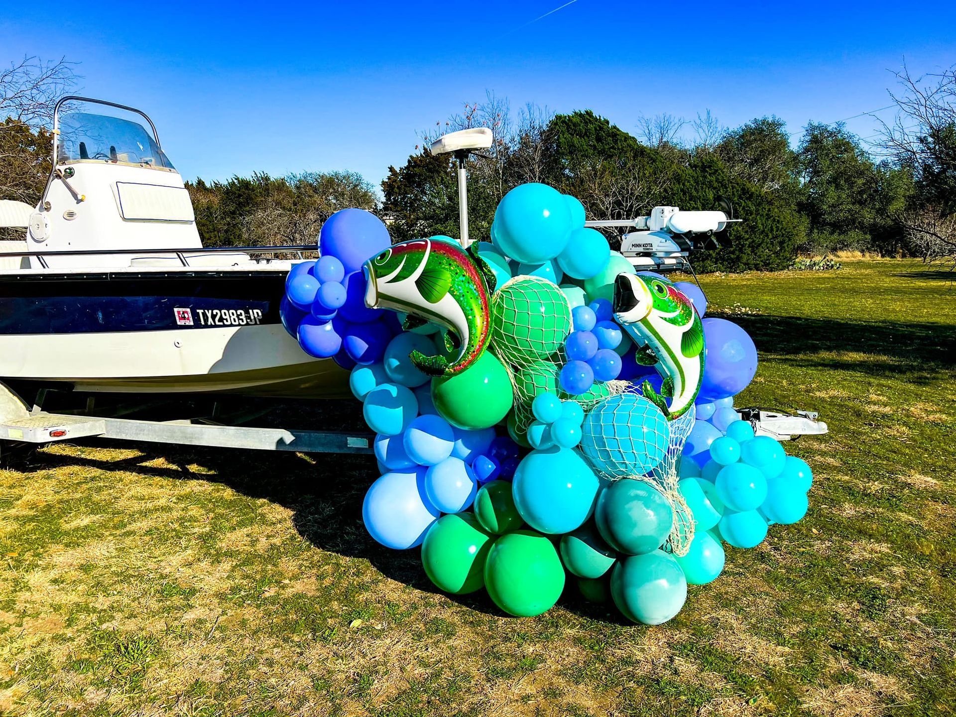 a boat is decorated with blue and green balloons