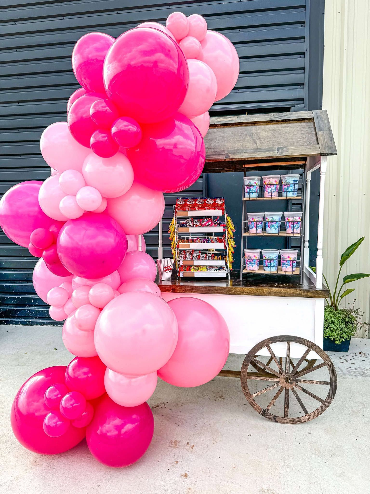 A dining room decorated for valentine 's day with balloons and a heart shaped balloon.