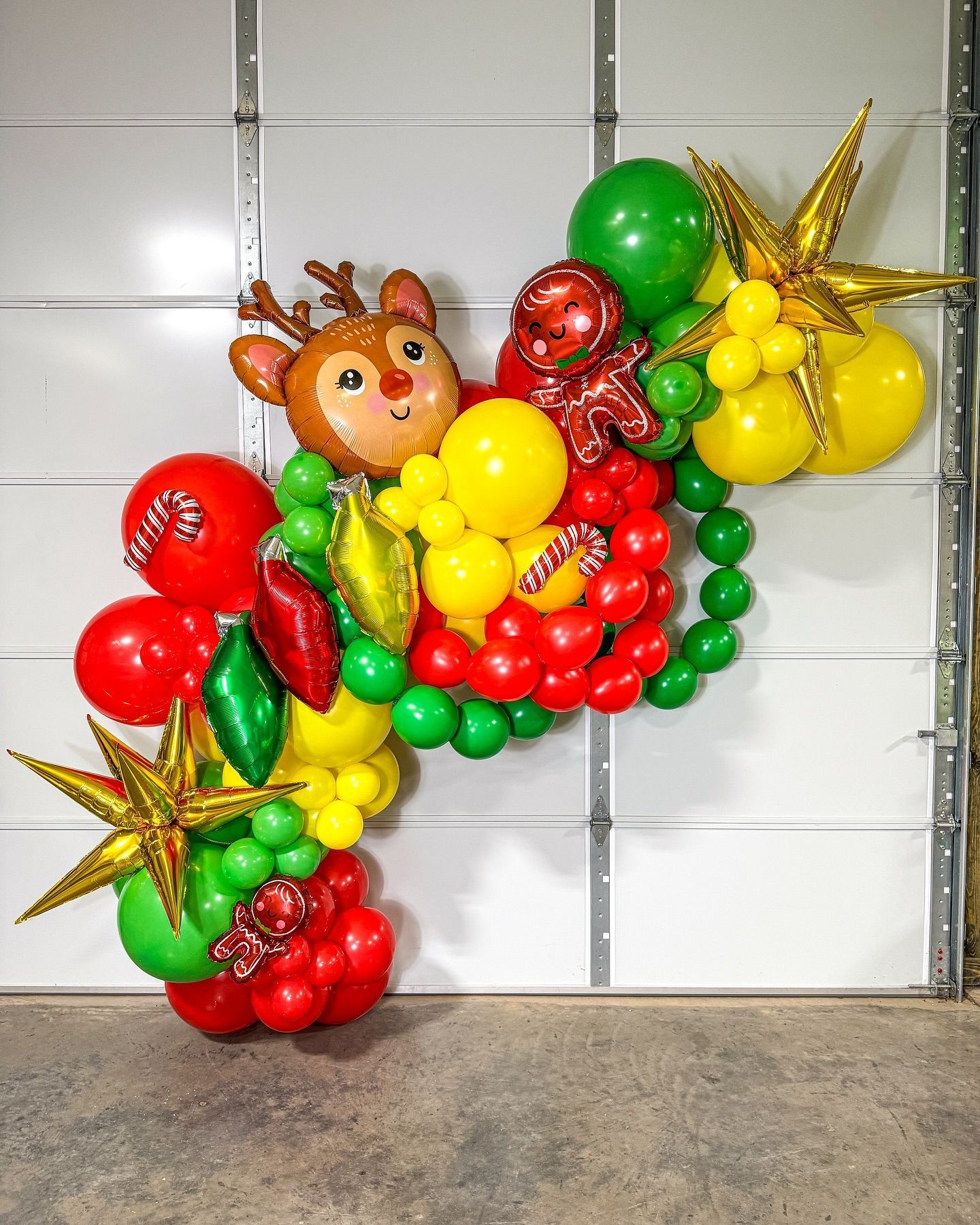 A bunch of balloons are hanging on a garage door.