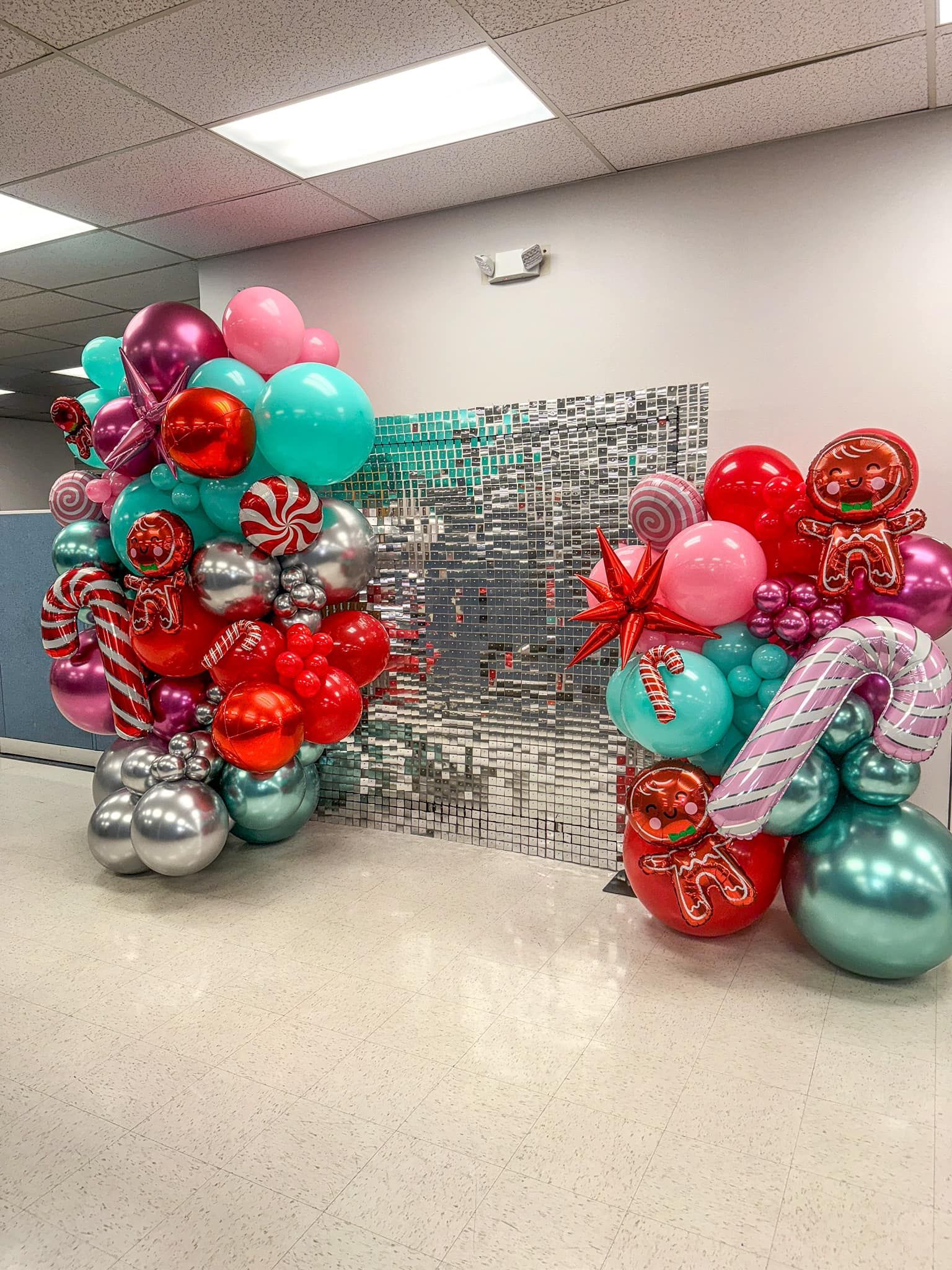 A bunch of balloons are sitting on the floor in a room.