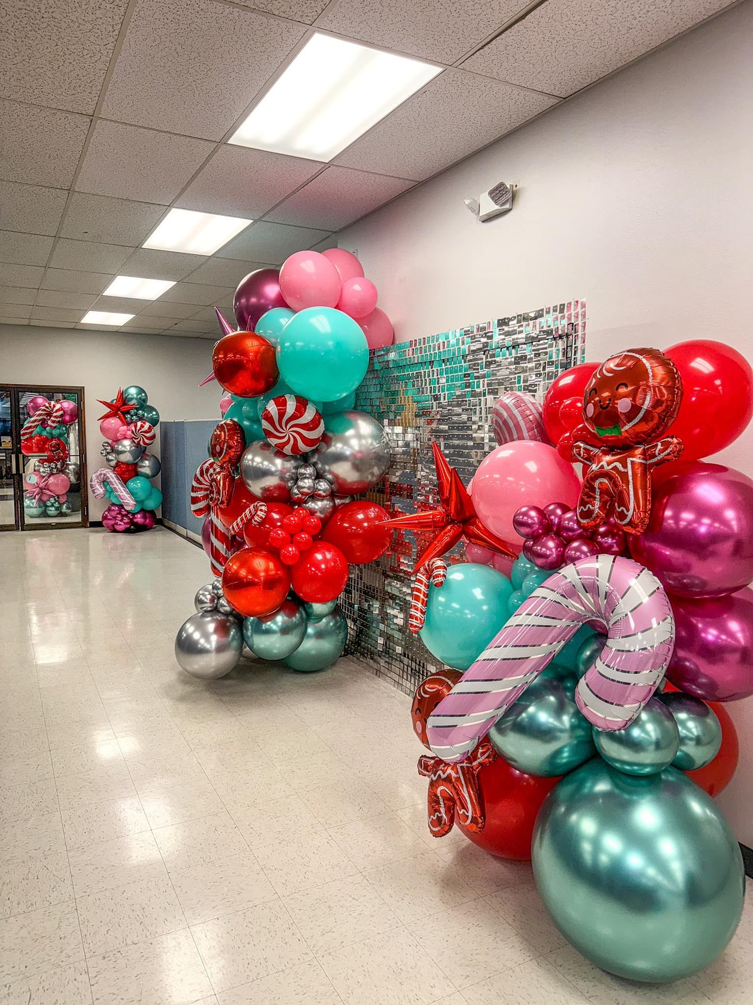 A room filled with lots of balloons and candy canes.