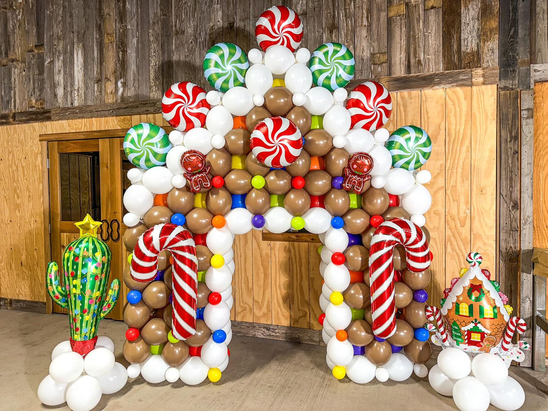 A gingerbread house made out of balloons and candies.