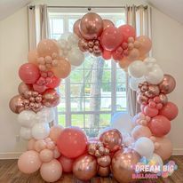 A room filled with lots of balloons and a window.