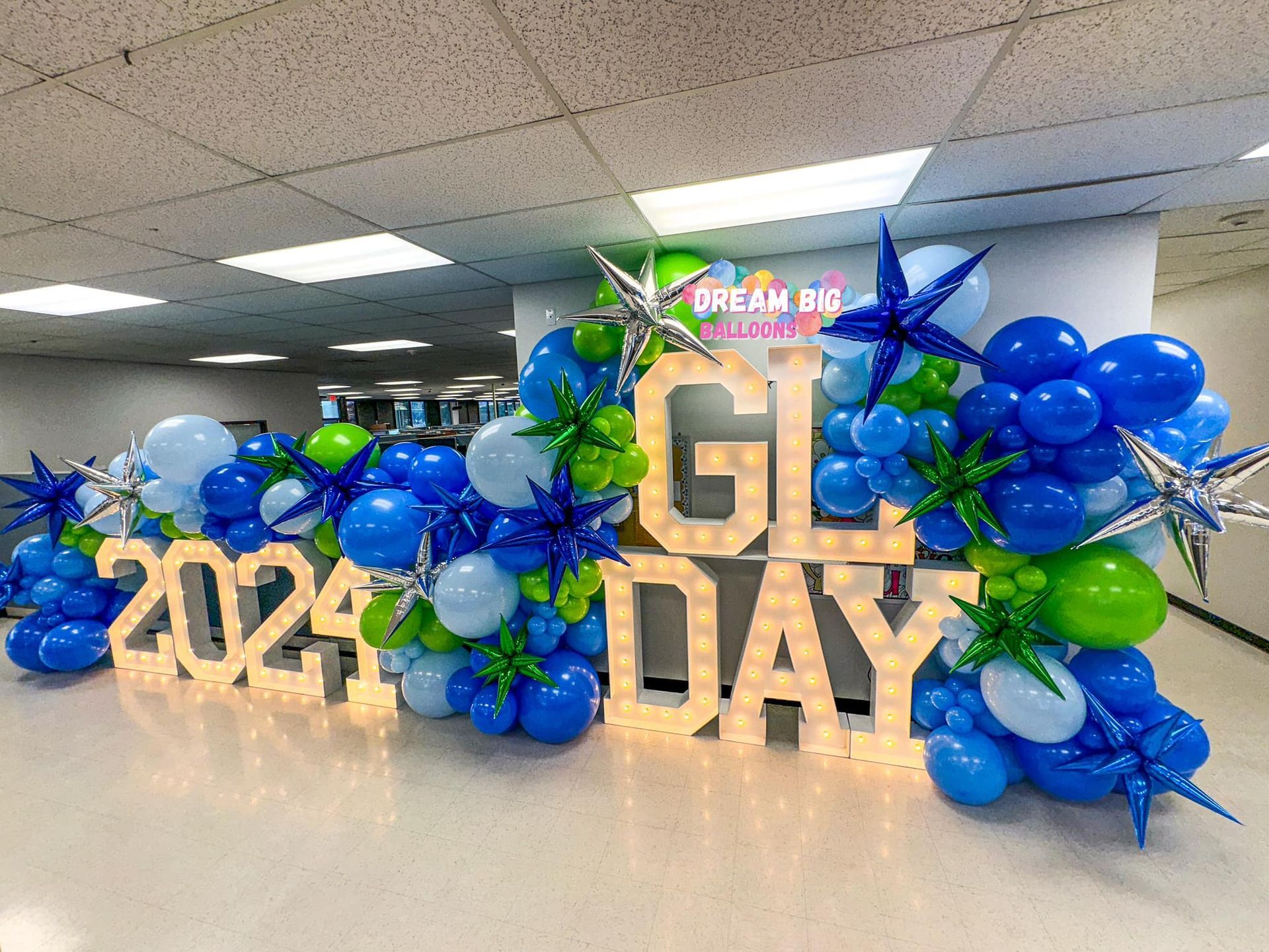 A room filled with blue and green balloons and letters.