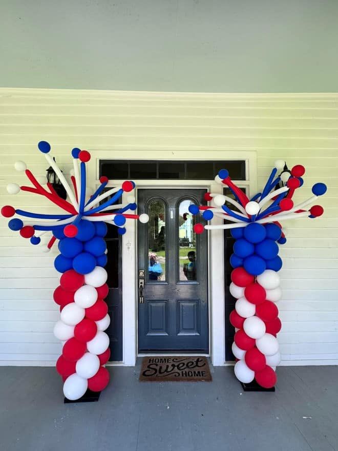 Red white and blue balloons decorate the front door of a house