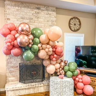 a living room filled with balloons and a fireplace